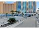 Resort-style pool with ample lounge chairs and blue umbrellas at 2700 Las Vegas Blvd # 809, Las Vegas, NV 89109