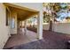 Covered patio overlooks a spacious backyard with mature trees and a gravel landscape at 272 Arbour Garden Ave, Las Vegas, NV 89148