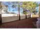 Landscaped backyard with mature trees and a block wall at 272 Arbour Garden Ave, Las Vegas, NV 89148