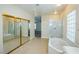 Bathroom boasts a soaking tub, shower, and mirrored closet at 272 Arbour Garden Ave, Las Vegas, NV 89148