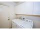 Bright laundry room with white cabinets and appliances at 272 Arbour Garden Ave, Las Vegas, NV 89148