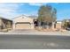 One-story home with a tan exterior and a two-car garage at 320 Via Del Duomo, Henderson, NV 89011