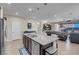 Open concept kitchen with island seating and views into the living room at 320 Via Del Duomo, Henderson, NV 89011