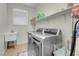 Bright laundry room, washer, dryer, and utility sink at 320 Via Del Duomo, Henderson, NV 89011