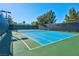 Inviting tennis court with blue surface and green surrounding at 320 Via Del Duomo, Henderson, NV 89011