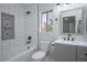 Bathroom with white subway tile surround, tub, decorative shelf, and vanity at 3335 Cheltenham St, Las Vegas, NV 89129