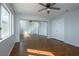 Bedroom with wood flooring, a ceiling fan, and mirrored closet doors at 3335 Cheltenham St, Las Vegas, NV 89129