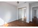 Bedroom features wood floors, a ceiling fan, and a closet with mirror doors at 3335 Cheltenham St, Las Vegas, NV 89129