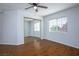 Bright bedroom with a ceiling fan, closet with mirror doors, and a window with natural light at 3335 Cheltenham St, Las Vegas, NV 89129