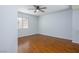 Bedroom with wood floors, neutral walls, one window with blinds and ceiling fan at 3335 Cheltenham St, Las Vegas, NV 89129