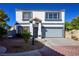 Two-story home exhibiting desert landscaping, a gray color scheme, and a two-car garage at 3335 Cheltenham St, Las Vegas, NV 89129