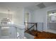 Upstairs landing featuring wood floors, decorative railing and views to the bathroom and bedroom at 3335 Cheltenham St, Las Vegas, NV 89129