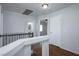 Upstairs hallway with wood floors and white doors leading to the bathroom and bedroom at 3335 Cheltenham St, Las Vegas, NV 89129