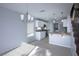 Open kitchen and dining area with modern lighting, white cabinets, and stainless appliances at 3335 Cheltenham St, Las Vegas, NV 89129