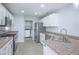 Well-lit kitchen with granite countertops, stainless steel appliances, and white cabinetry at 3335 Cheltenham St, Las Vegas, NV 89129