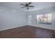 Hardwood floors flow throughout the living room featuring an exterior door and large windows at 3335 Cheltenham St, Las Vegas, NV 89129