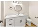 Modern bathroom with white vanity, quartz countertop, and circular mirror at 3400 Cabana Dr # 1108, Las Vegas, NV 89122