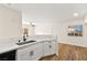 Open kitchen with white cabinets, quartz countertops, and a stainless steel sink at 3400 Cabana Dr # 1108, Las Vegas, NV 89122