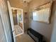 View down a hallway to a bathroom with a chandelier, mirror and bench at 3550 Bay Sands Dr # 3073, Laughlin, NV 89029