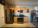 Modern kitchen with wood cabinets and black appliances at 3550 Bay Sands Dr # 3073, Laughlin, NV 89029