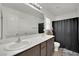 Bathroom with double sinks, shower, and linen storage at 4151 San Cuervo Way, Las Vegas, NV 89115