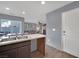 Modern kitchen features dark brown cabinets, stainless steel appliances, and a large island at 4151 San Cuervo Way, Las Vegas, NV 89115