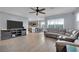 Open concept living room with kitchen view and gray sectional sofa at 4151 San Cuervo Way, Las Vegas, NV 89115