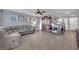 Living room with gray sectional sofa, wood floors, and built-in shelving at 4151 San Cuervo Way, Las Vegas, NV 89115