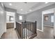 Upstairs hallway with dark wood railing and access to bedrooms and bath at 4151 San Cuervo Way, Las Vegas, NV 89115