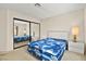 Spacious bedroom with mirrored closet doors and carpeted floor at 433 Old Palms Dr, Las Vegas, NV 89123