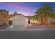 House exterior at dusk, showcasing the front yard and garage at 433 Old Palms Dr, Las Vegas, NV 89123