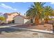 House exterior with a two-car garage and palm trees at 433 Old Palms Dr, Las Vegas, NV 89123