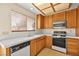 Kitchen with wood cabinets, appliances, and tile floor at 433 Old Palms Dr, Las Vegas, NV 89123