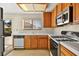 Kitchen with wood cabinets, white countertops, and microwave at 433 Old Palms Dr, Las Vegas, NV 89123