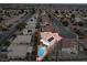 Aerial view of single-story house with solar panels and a refreshing blue swimming pool in the backyard at 4417 Socrates St, North Las Vegas, NV 89031