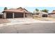 House exterior showcasing a two-car garage and landscaped yard at 4417 Socrates St, North Las Vegas, NV 89031