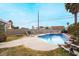 Inviting swimming pool with lounge chairs in the backyard at 4417 Socrates St, North Las Vegas, NV 89031