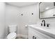 Modern bathroom with white vanity, toilet and black accents at 491 Kristin Ln, Henderson, NV 89011