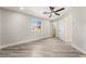 Bedroom with wood-look floors, ceiling fan, and window at 491 Kristin Ln, Henderson, NV 89011