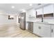 Modern kitchen with white cabinets, stainless steel appliances, and quartz countertops at 491 Kristin Ln, Henderson, NV 89011