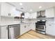 Modern kitchen with white shaker cabinets and stainless steel appliances at 491 Kristin Ln, Henderson, NV 89011