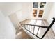 View from the top of the stairs, showing the living area and large window at 491 Kristin Ln, Henderson, NV 89011