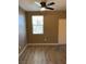 Well-lit bedroom with large window and wood-look flooring at 50 Aura De Blanco St # 13103, Henderson, NV 89074