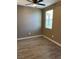 Bright bedroom with gray walls, wood-look floors and a window at 50 Aura De Blanco St # 13103, Henderson, NV 89074