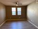 Simple bedroom with gray walls, wood-look floors and ceiling fan at 50 Aura De Blanco St # 13103, Henderson, NV 89074