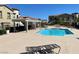 Community pool with lounge chairs and shaded seating at 50 Aura De Blanco St # 13103, Henderson, NV 89074