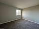 Bright bedroom with grey carpet and a large window at 5181 River Glen Dr # 172, Las Vegas, NV 89103