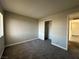 Spacious bedroom with grey carpet, closet, and window at 5181 River Glen Dr # 172, Las Vegas, NV 89103