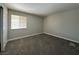 Well lit bedroom with grey carpet and window at 5181 River Glen Dr # 172, Las Vegas, NV 89103