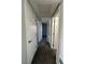 Hallway with carpeted flooring and doors leading to bedrooms and bathroom at 5181 River Glen Dr # 172, Las Vegas, NV 89103